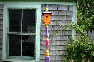 Colorful bird house on a post