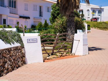 Cozy brick path and rustic gate entrance in a Mediterranean setting.