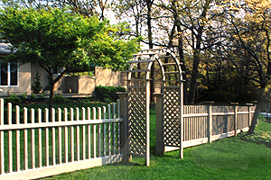 White vinyl picket fence with arbor